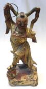 A Chinese gilded and painted Treen Model of an Acrobat or Circus Performer wearing ceremonial robes,