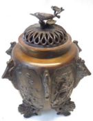 A Japanese Bronze Koro, the base bearing the Guan Yin mark, embossed with panels of birds and