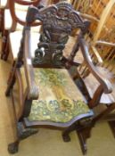 A 19th Century Mahogany framed Armchair with heavily carved Gothic back, with stylised green man