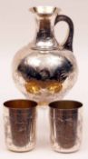 A Victorian Silver parcel gilt Ewer and two Tumbler Cups, the Ewer with a waisted throat, with a