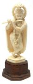 An Indian carved Ivory Figure of a Female Musician with a flute and wearing ceremonial clothing,