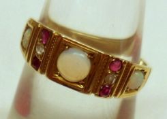 A vintage 18ct Gold three small Opal, four small Ruby and two small Diamond Ring, stamped “18ct”.