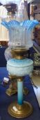 A large Victorian Oil Lamp with round Brass base, to a turquoise shaded column, a turquoise/cream