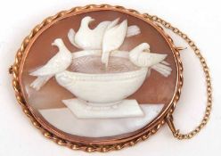 An unmarked yellow metal framed Shell Cameo Brooch of Doves on a fountain, rope twist edge,