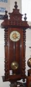 A last quarter of the 19th Century Stained Wood Cased Vienna Wall Clock of architectural design with