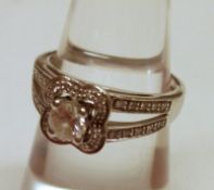 A high grade precious metal Ring set with a centre brilliant cut Diamond of approximately.2ct, the