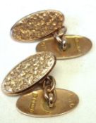 A pair of late Victorian foliate engraved oval 9ct Gold Cufflinks with chain separators,