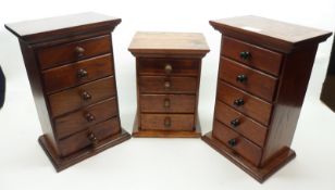 A group of three small Mahogany and stained wood Chests, two with five drawers, one with four