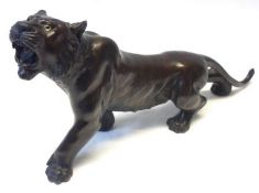 A Meiji Bronze Model of a Tiger, seal mark to belly and one eye missing, 6” high.