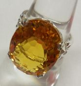 A white metal centre large oval cut Citrine Dress Ring, approximately 12ct, the shoulder each