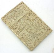 A well carved Ivory Card Case of rectangular form, ornately carved with Pagodas, figures, palm