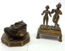 An Oriental Brass Model of a crouching Toad, together with a group of two Eastern Dancing Figures on