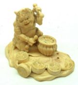 An Oriental Ivory Model of a Demon and Drums, etc, 2 ½” high.