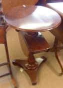 A 19th Century Mahogany two tier Dumb Waiter, the round top to a turned pedestal and a second drop