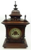 A late 19th Century Mahogany Mantel Clock, with moulded urn pediment, circular face with Arabic