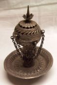 A foreign white metal Incense Burner, having embossed circular tray base, engraved stem, with