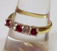 A hallmarked 18ct Gold two small brilliant cut Diamonds and three small Ruby line set Ring, the