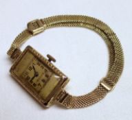 A Ladies Vintage hallmarked 18ct Gold cased Rolex Wristwatch, Arabic numbers to a rectangular Gold