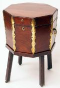 A George III Mahogany Wine Cooler, octagonal shape with Brass mounts, on a Table base with four