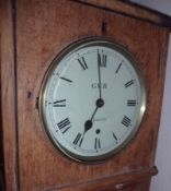 An Oak Wall Clock, the circular face with spun Brass bezel and enamelled Roman chapter ring, with
