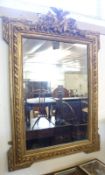 A large 19th Century Wall Mirror, in gilt/gesso frame with central foliage and bird mount, 47” high.