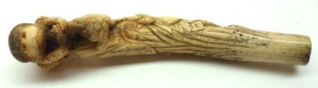 An Oriental Ivory Parasol or Stick Handle, carved with baboon and frogs, etc, 6 ¼” long.