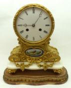 A late 19th Century gilt metal cased balloon shaped Mantel Clock, the circular enamelled face with