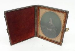 A 19th Century Ambrotype Photograph of a seated lady, in red Leather folding Case with Brass