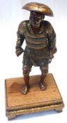 A Miyao Eisuke signed Japanese gilded Bronze Model of a Fisherman, on a Rosewood base, standing