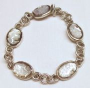 A white metal Bracelet featuring five carved Mother of Pearl cameo panels of a classical lady
