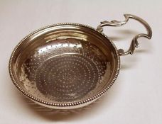 A George III Lemon or Punch Strainer, circular shaped with gadrooned rim, pin-pricked bowl, open
