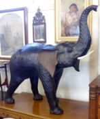 A 20th Century Black Leather covered Model of a baby Elephant with raised trunk and composition