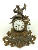 A French gilt metal Mantel Clock, crested with a figure of a seated Fisherman, on a pierced Rococo