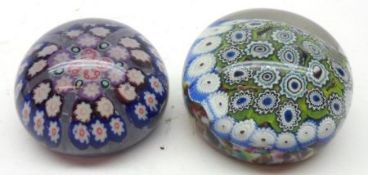 A 20th Century Paperweight inset with a Millefiori scramble design on a predominantly green carpet