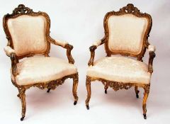 A pair of late 19th Century Continental Louis XV style Armchairs, the gilt wood frame with short