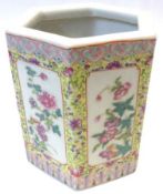 An Oriental hexagonal Brush Pot, decorated in famille rose and verte with panels of folige on a
