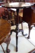 A small 19th Century Mahogany pedestal Wine Table, the round flip-top with scalloped edge, raised on