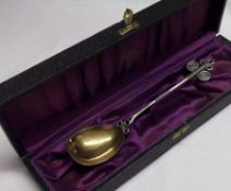 A Scandinavian cased white metal Souvenir Spoon with gilded egg shaped bowl, stylised handle, 6 ¼”