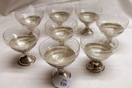 A set of eight early 20th Century white metal Champagne/Cocktail Glass Holders of circular footed