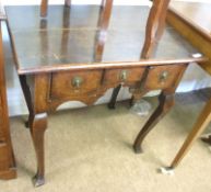 A 19th Century Oak cabriole legged three drawer Lowboy with Brass ringlet handles, 29” wide.