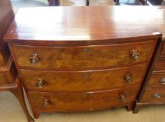 A Victorian Mahogany bow front three drawer Chest with turned knob handles, raised on small