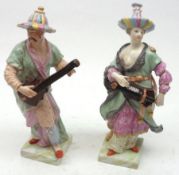 A pair of late 19th Century Berlin Figures modelled as Male and Female Musicians, decorated in