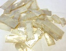 A packet of 28 Oriental Mother of Pearl Gaming Tokens, rectangular and square shaped, all with
