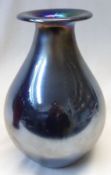 An iridescent Art Glass baluster Vase with everted rim and tapering body, 9 ½” high.
