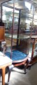 A late Victorian/Edwardian glazed Shop Display Cabinet, fitted with door to back and bowed glass