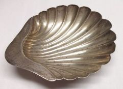 A late Victorian Butter Dish of shell form, supported on three shell feet, 3 ¾” x 4” maximum,