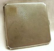 A George V Cigarette Case of shaped square design, engine turned decoration, vacant cartouche, 3”