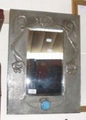 A rectangular bevelled Wall Mirror in a Pewter Arts & Crafts style floral embossed frame, bears no