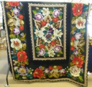 A large hand worked late 19th Century Tapestry Bedcover/Wall Hanging, black ground bordered by