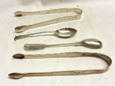 A Mixed Lot comprising: A pair of George III bright cut Sugar Tongs, Old English pattern, with acorn